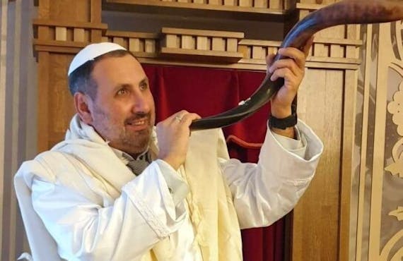 Rabbi Reuven Stamov blows the shofar on the High Holidays in Ukraine.